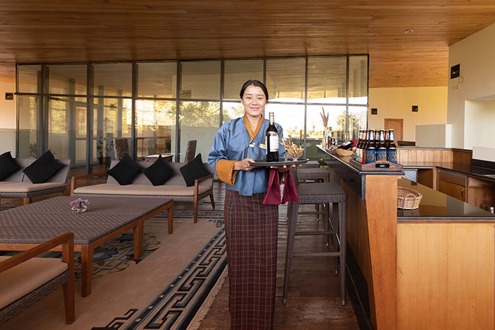 Zhiwaling Ascent, Thimphu - rooftop area, lady standing welcoming